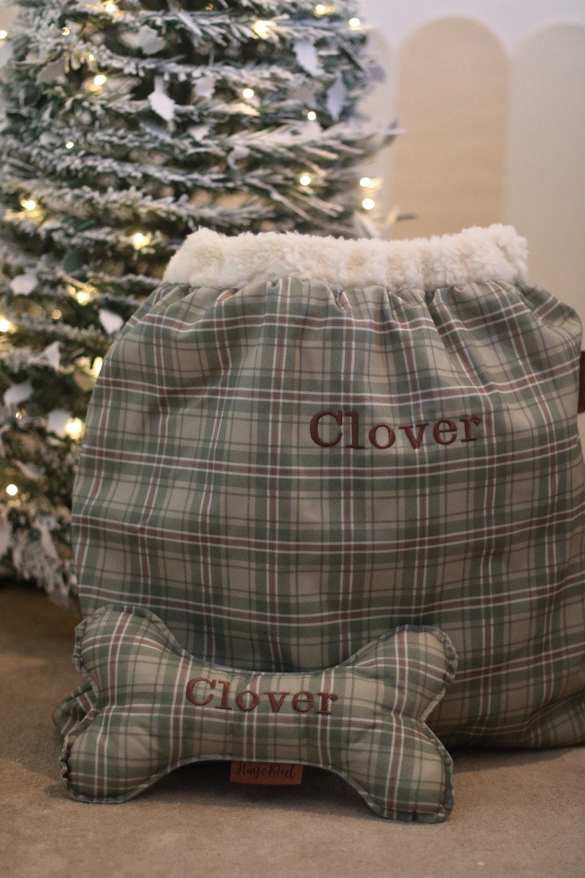 Heritage check personalised present sack and wonky bone by a Christmas tree